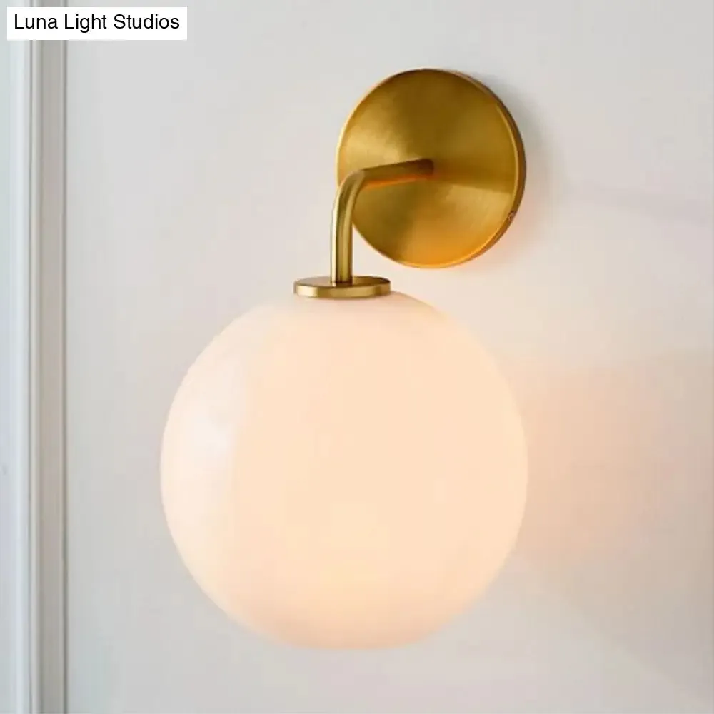 Modern Glass Orb Wall Sconce with Brass Arm, Clear/White