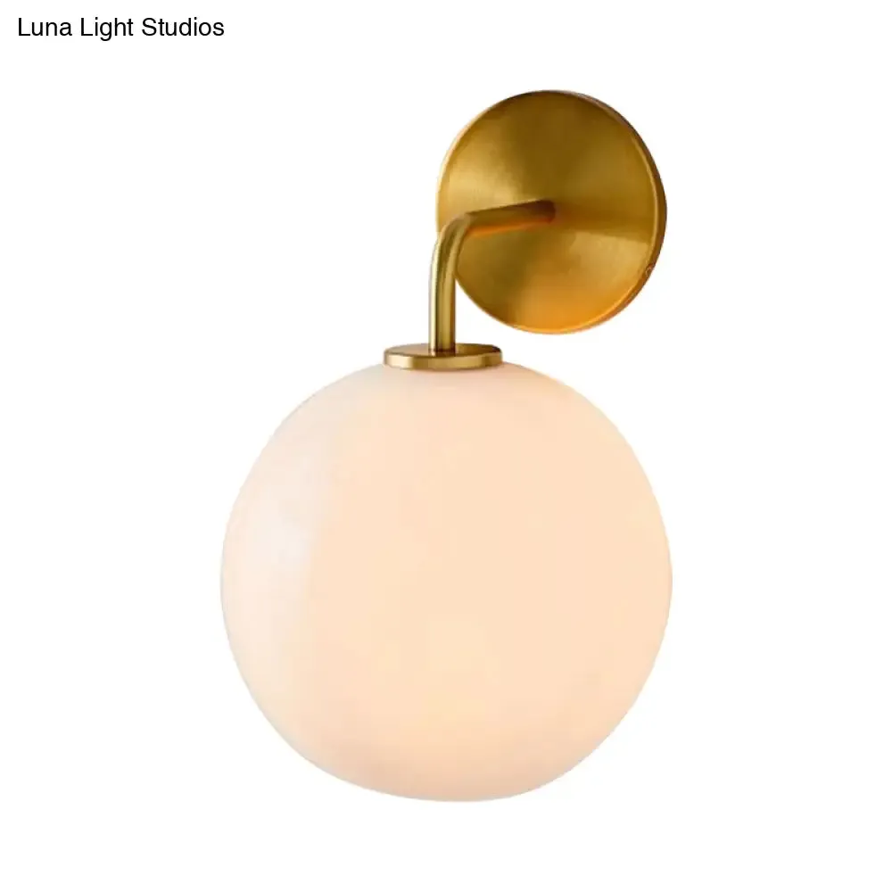 Modern Glass Orb Wall Sconce with Brass Arm, Clear/White